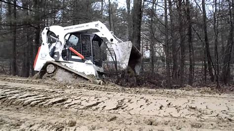 how to get a bottomed out skid steer unstuck|skid steer stuck in mud.